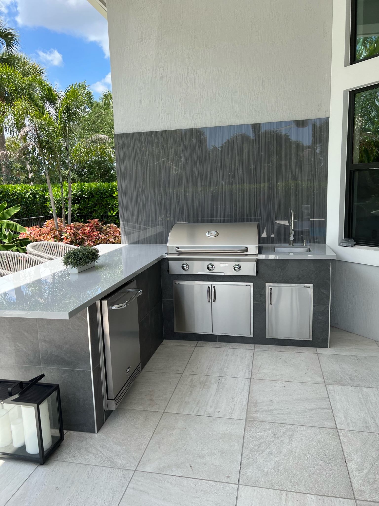 Built-in AOG grill, counter and sink in an outdoor kitchen, published by Tropical Flames